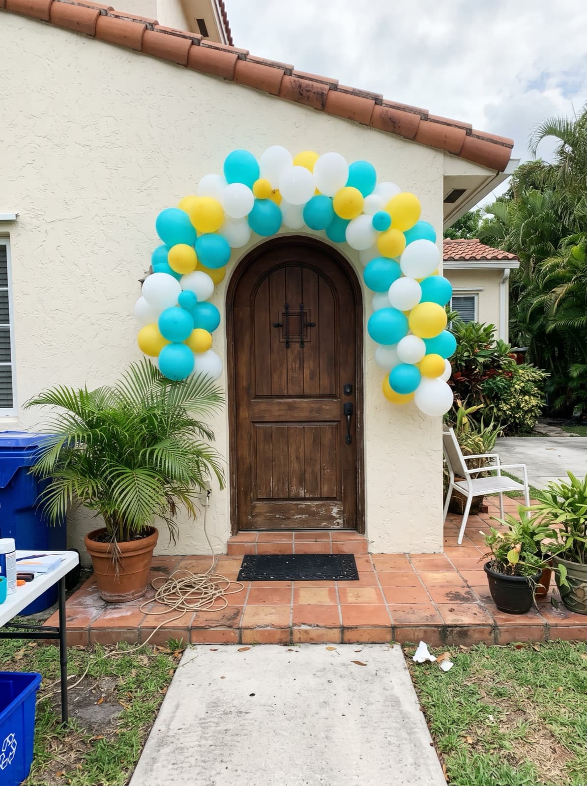 Balloon arch over the front door of a Mediterranean-style house