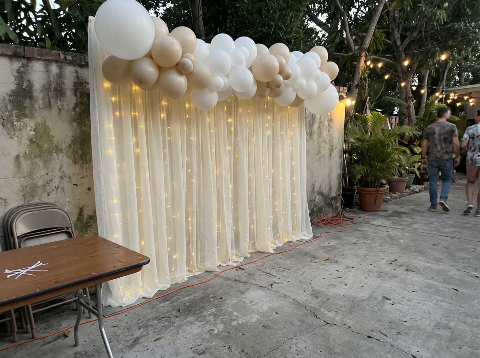 Draped backdrop with balloons and lights