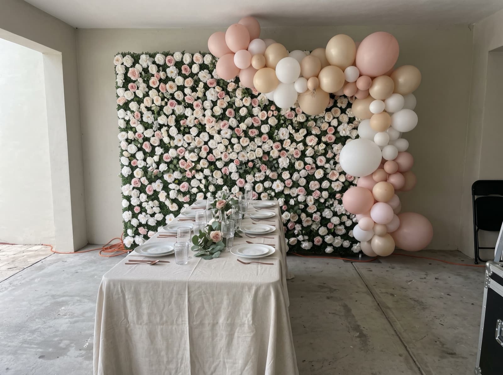 Flower wall backdrop with blush balloons for a bridal shower