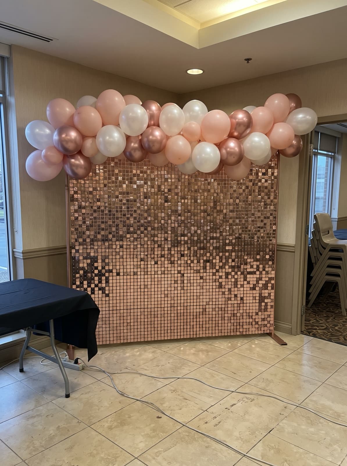 Rose gold sequin wall with a blush balloon garland