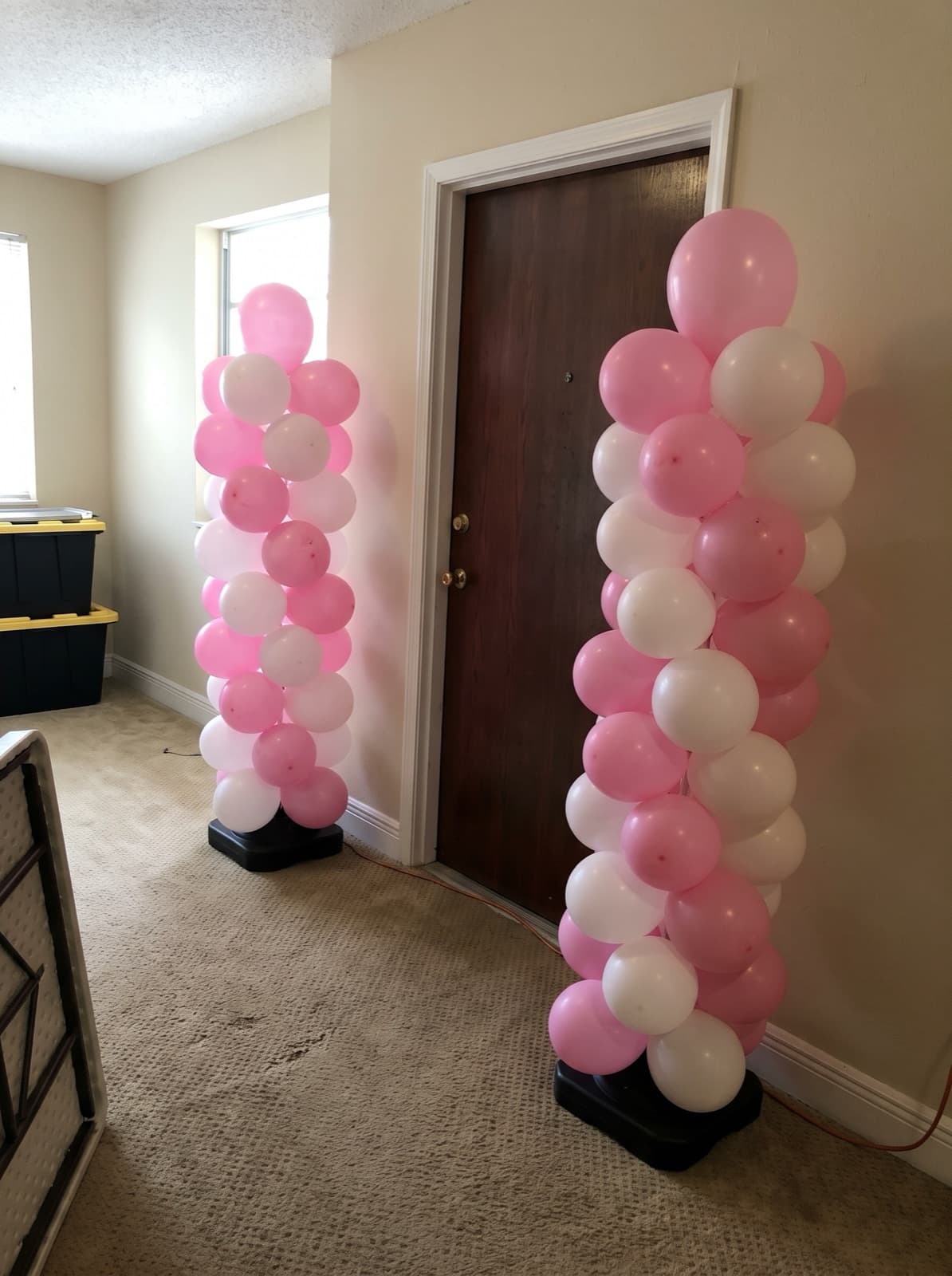 Pair of spiral balloon columns at a condo apartment door
