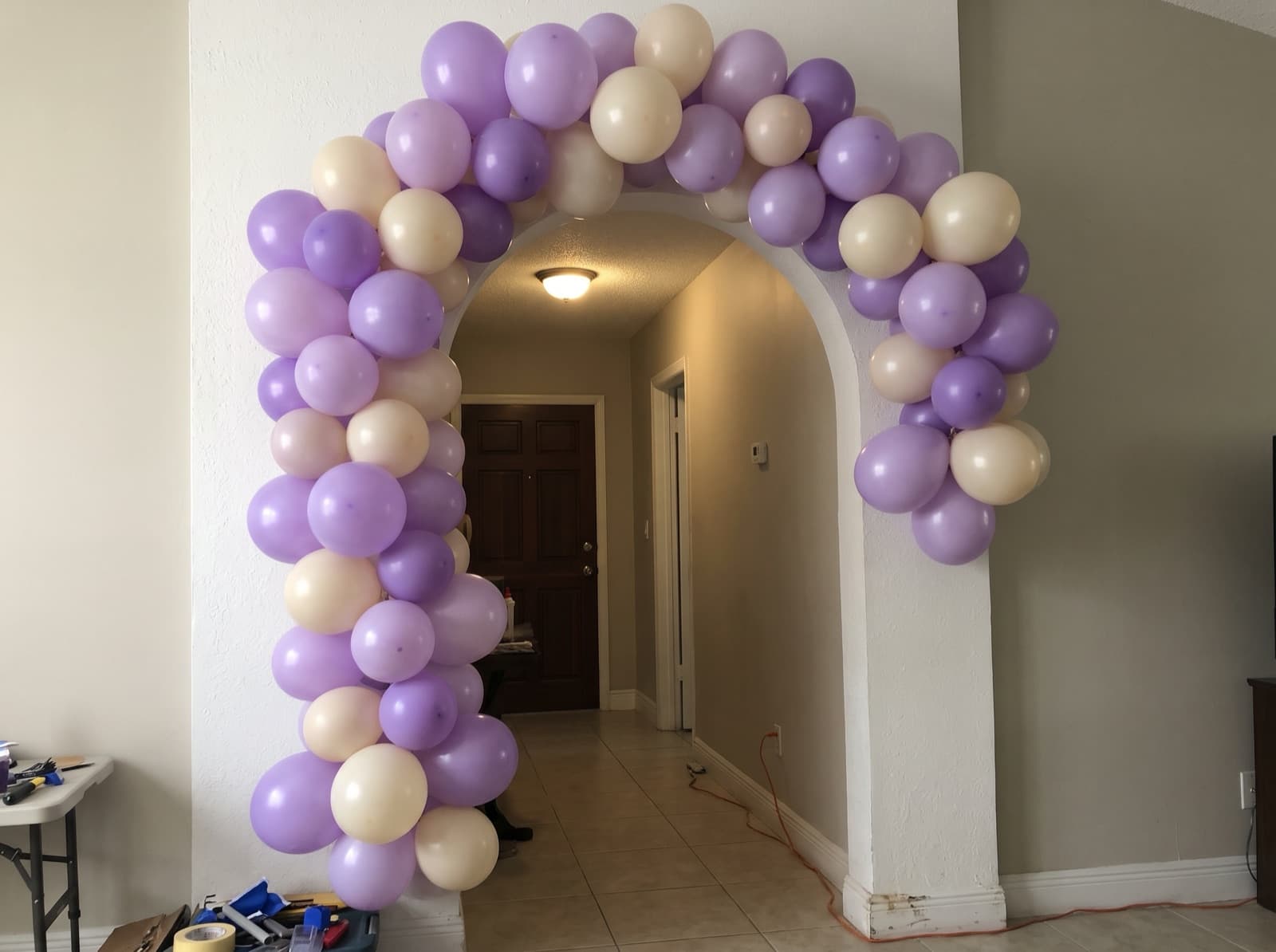 Balloon garland climbing around an arched interior doorway