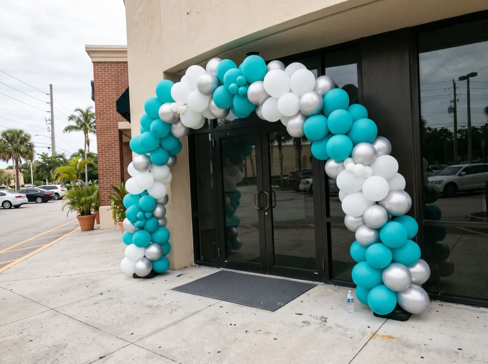 Giant balloon arch installation over a storefront