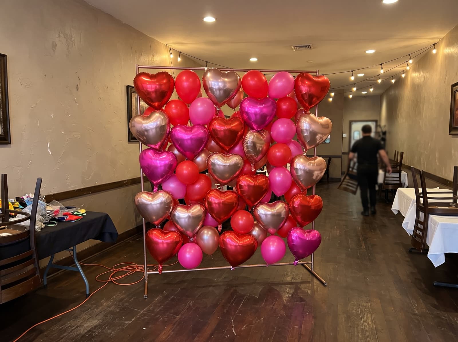 Wall of red and pink foil heart balloons